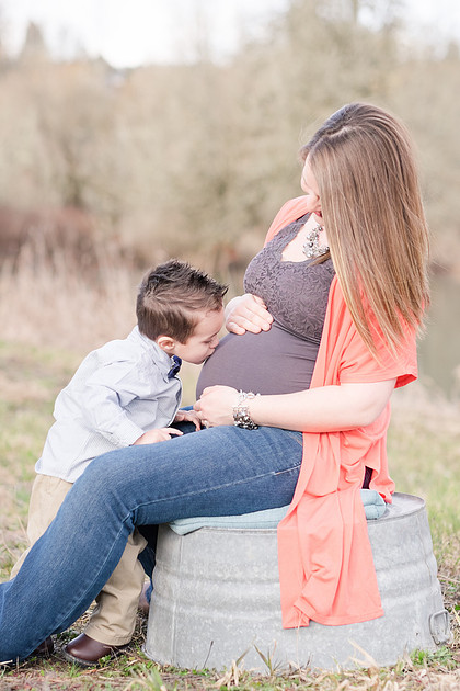 "Maternity pictures with sibling" "Sibling kissing baby bump" "Washington State family photographer"