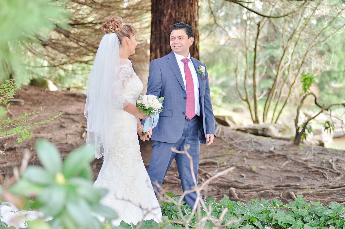 Bride and groom walking in forest