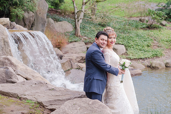 Bride and groom in front of waterfall